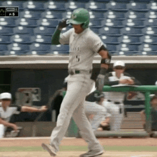 a baseball player with the number 5 on his shirt is walking on the field