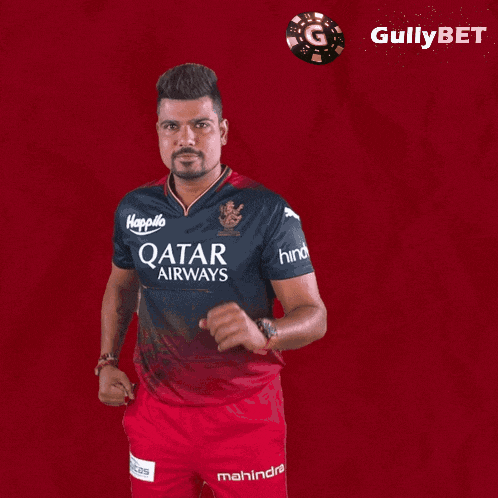 a man is wearing a qatar airways shirt and shorts