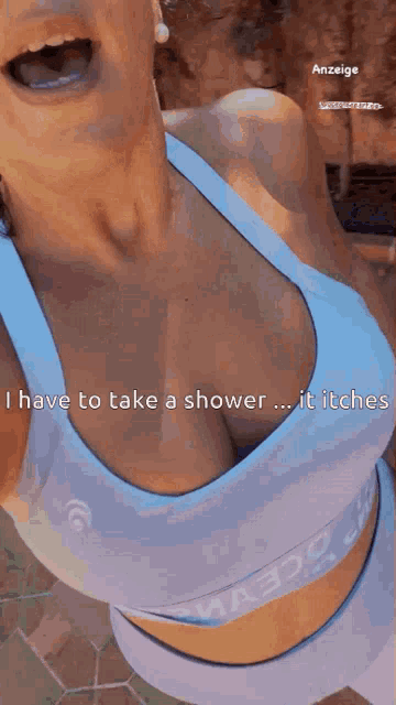 a woman in a blue sports bra says i have to take a shower it itches