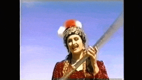 a woman in a red dress is holding a large sword in front of a blue sky