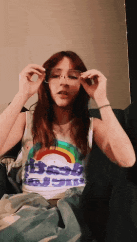 a woman wearing a tank top that says ' best ' on it