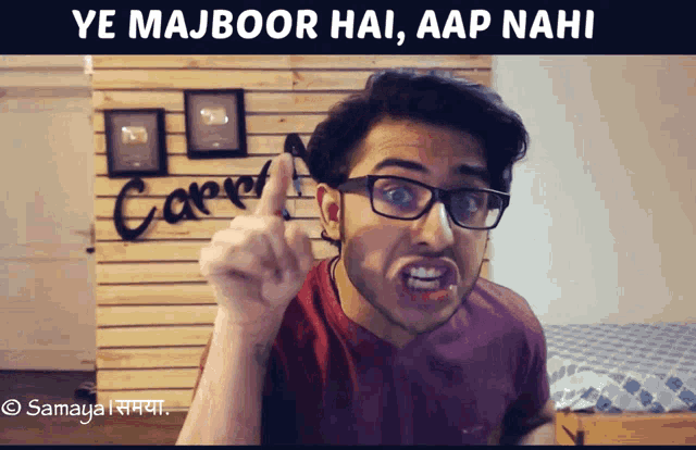 a man wearing glasses is making a funny face with the words ye majboor hai aap nahi above him