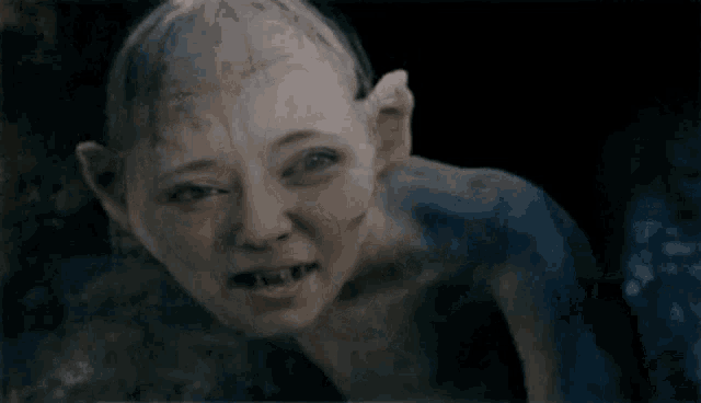 a close up of a person with a shaved head and without a shirt .