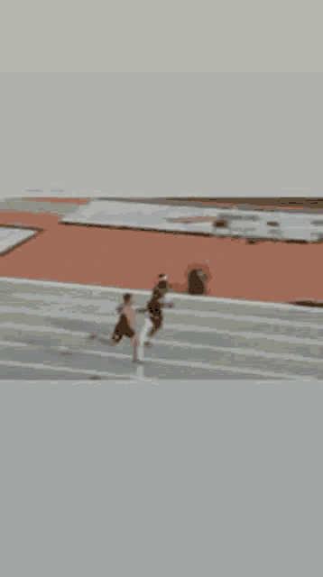 a blurred image of a track and field race with a sign that says ht