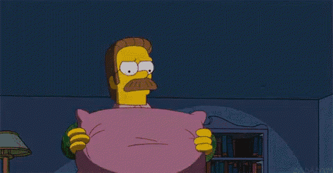 a cartoon character holding a pink pillow with a face on it .