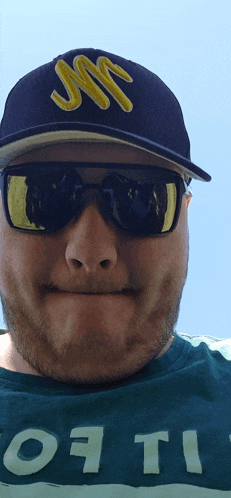 a man wearing sunglasses and a hat that says jms on it