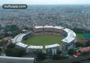 an aerial view of a cricket stadium with the words kulfyapp.com at the bottom