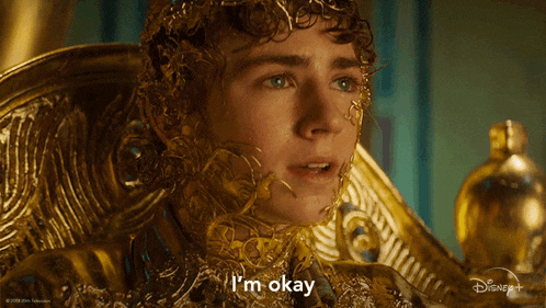 a man is wearing a gold costume and says i 'm okay