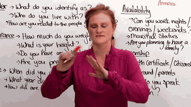 a woman stands in front of a whiteboard that says " availability "
