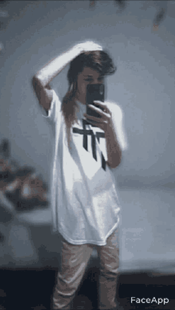 a person wearing a white shirt with a cross on it