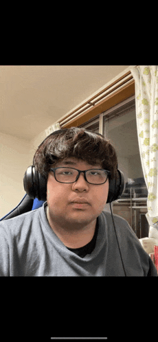 a man wearing glasses and headphones is taking a selfie