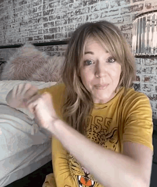 a woman wearing a yellow t-shirt with a leopard on it