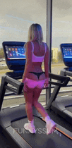 a woman is walking on a treadmill in a gym .