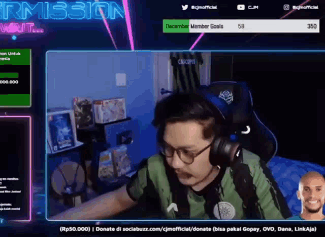 a man wearing headphones and glasses is playing a video game