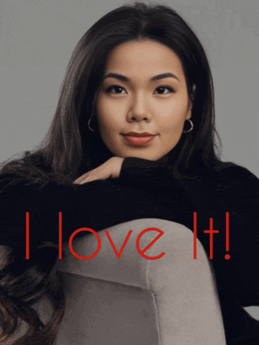 a woman in a black turtleneck sits on a chair with the words i love it
