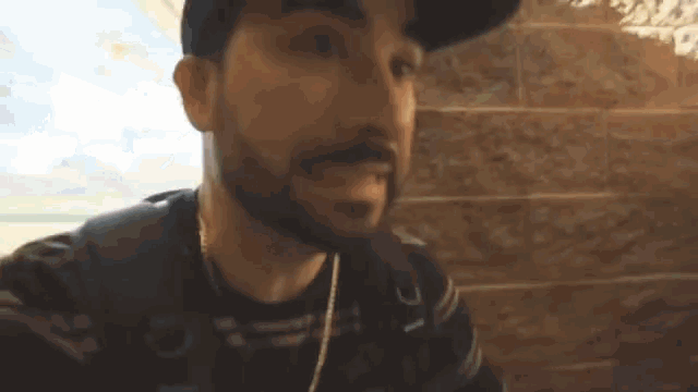 a man with a beard is wearing a hat and earphones