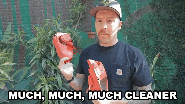 a man holding a red object with the words much much much cleaner written below him