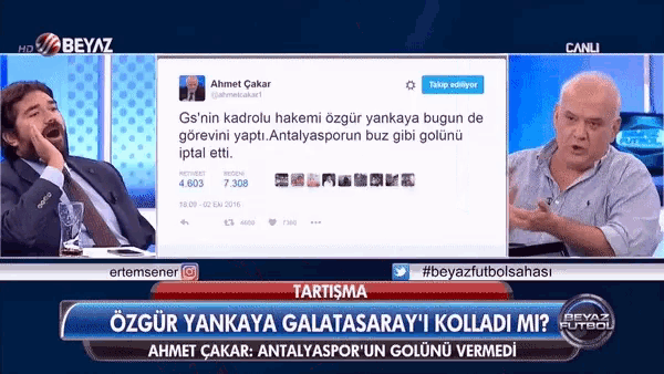 two men are sitting in front of a screen that says " canli "