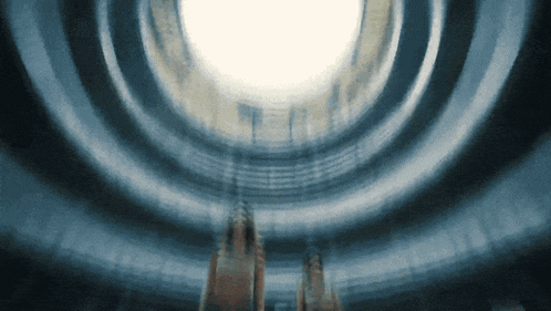 a blurred image of a building with a light shining through the ceiling