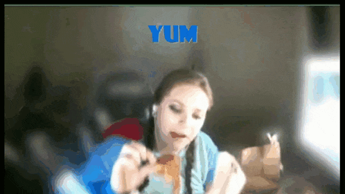 a woman is eating a hamburger with the word yum in the background
