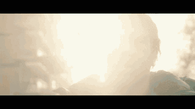a close up of a person 's face with the sun shining on it .