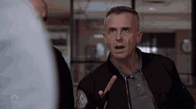 a man wearing a jacket with a patch that says fox on it