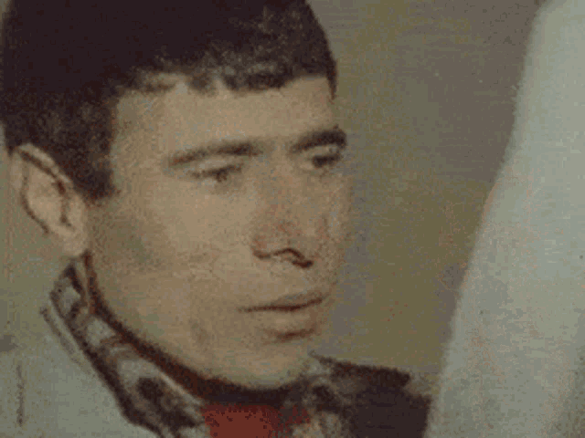 a blurry picture of a man holding a white cloth