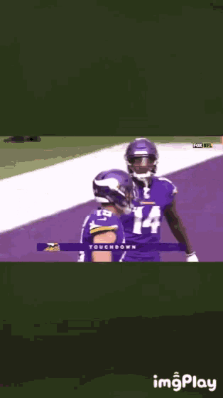 a football player in a purple jersey with the number 4 on the back
