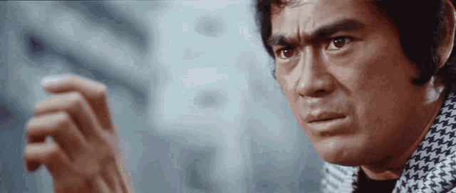 a close up of a man 's face and hand