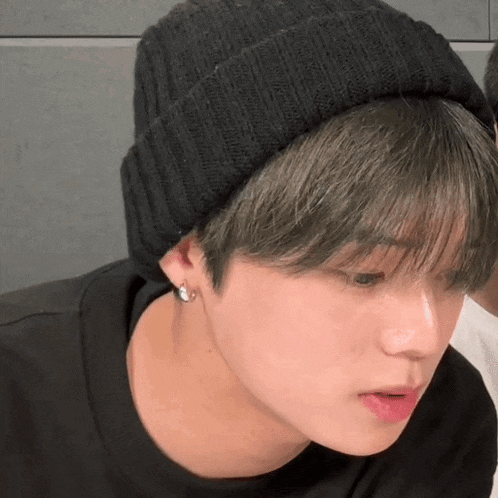 a close up of a person wearing a black beanie