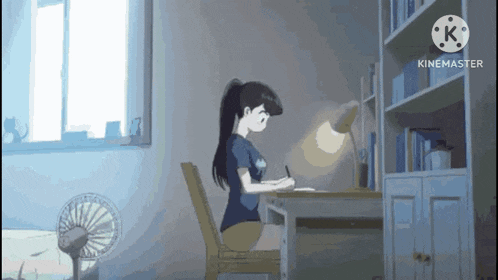 a girl is sitting at a desk in a room with a fan and a light on .