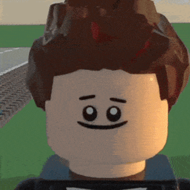 a close up of a lego man 's face with a smiley face .