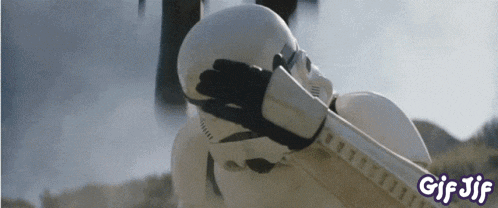 a storm trooper from star wars covering his face with his hand ..