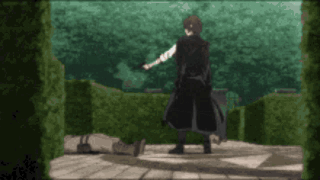 a man in a black coat is standing next to a man laying down