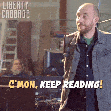 a man in a denim jacket says " c'mon keep reading " while standing in front of a computer