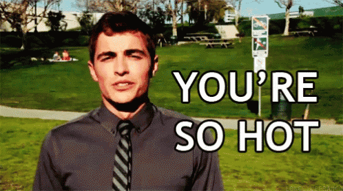 a man in a grey shirt and tie says you 're so hot