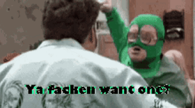 a man wearing a green mask is talking to another man wearing a green mask