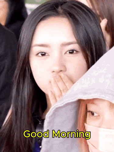 a woman covering her mouth with her hand and the words " good morning " behind her