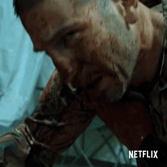 a close up of a man with blood on his face and a netflix logo behind him