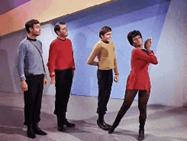 a group of people are standing next to each other and one of them is dancing