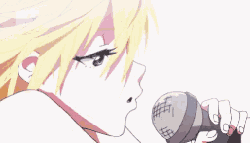 a girl is singing into a microphone with her mouth wide open