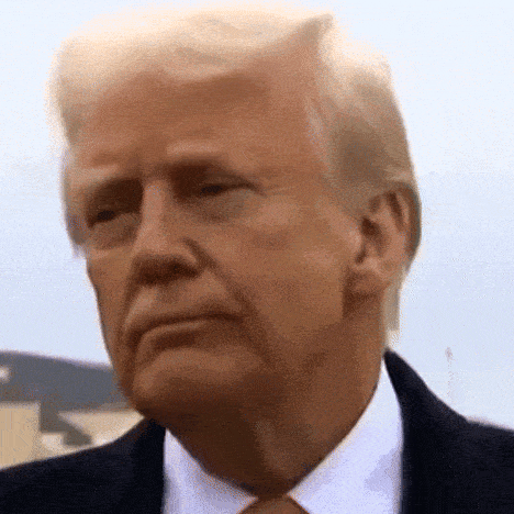 a close up of donald trump 's face wearing a suit and tie