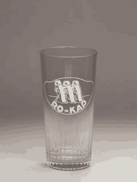 a clear glass with the word ro-kap etched on it