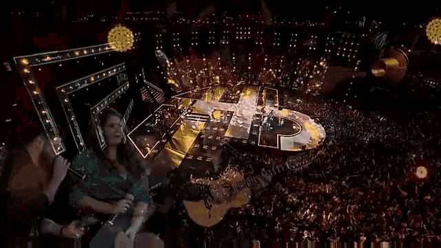 a man is playing a guitar while a woman sings into a microphone .
