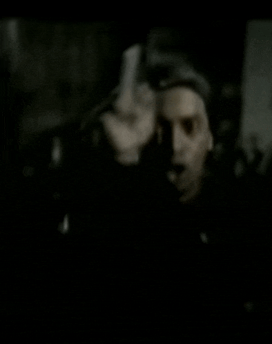 a man wearing a nike headband points at something