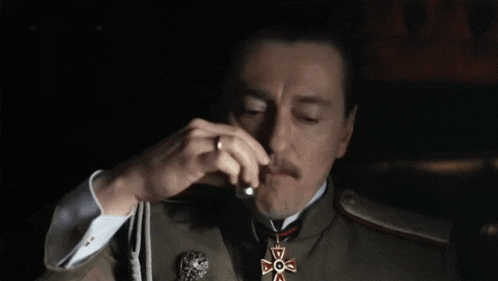 a man in a military uniform has a medal around his neck with a cross on it