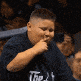 a young boy wearing a shirt that says the j on it