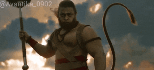 a man with a beard and a monkey tail holds a pole in his hand