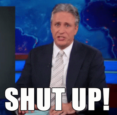 a man in a suit and tie says shut up in front of a world map