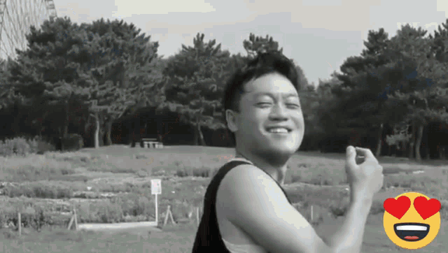 a black and white photo of a smiling man with a heart shaped eye